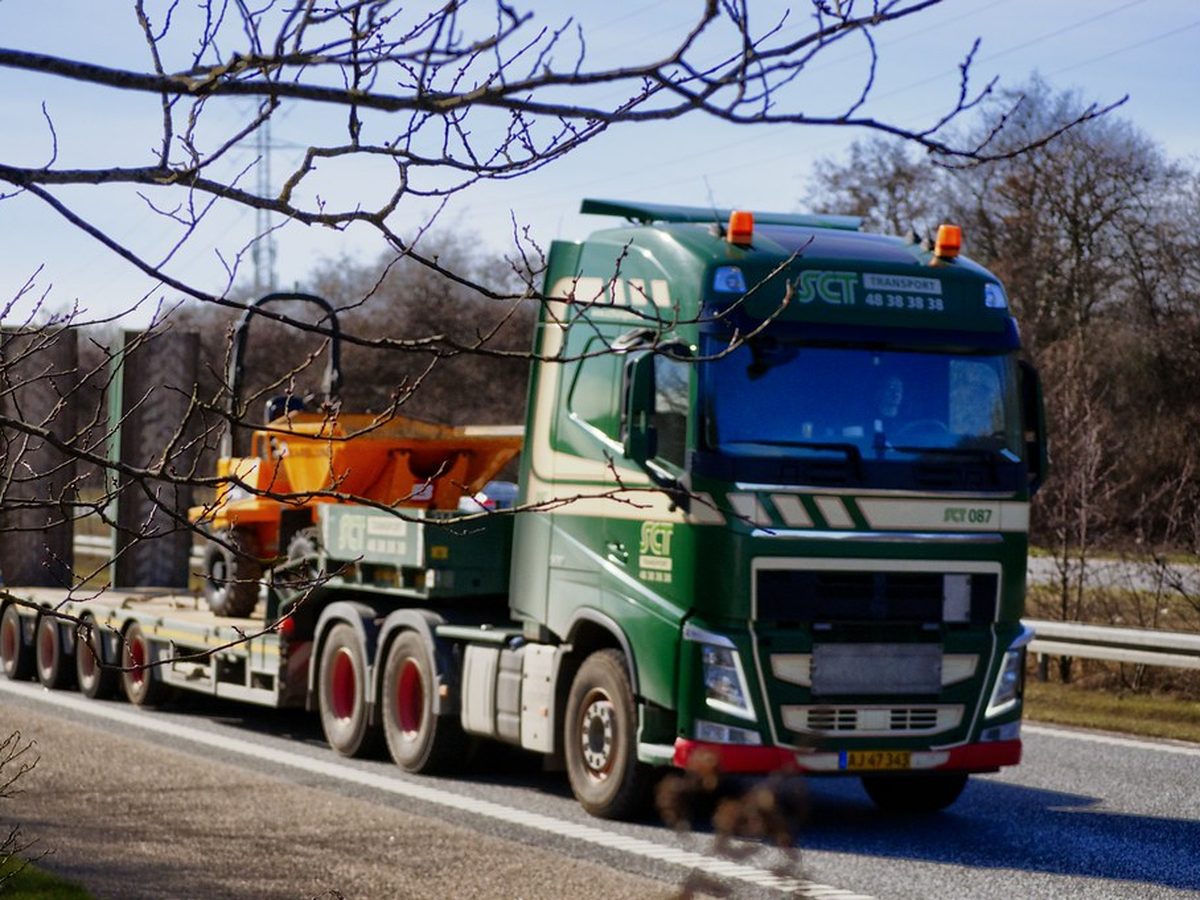 A machine loaded on a low-bed trailer, secured for a long-haul road movement
