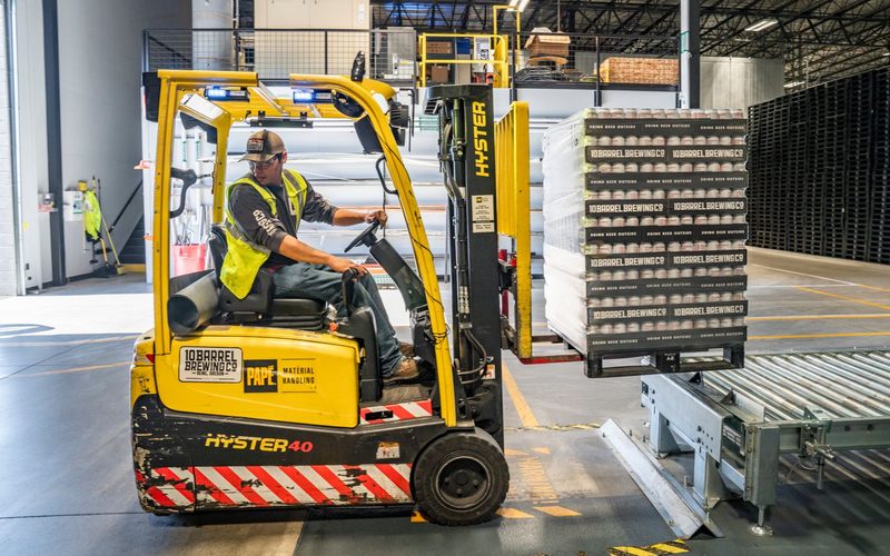 Forklift loading palletised goods for door-to-door delivery